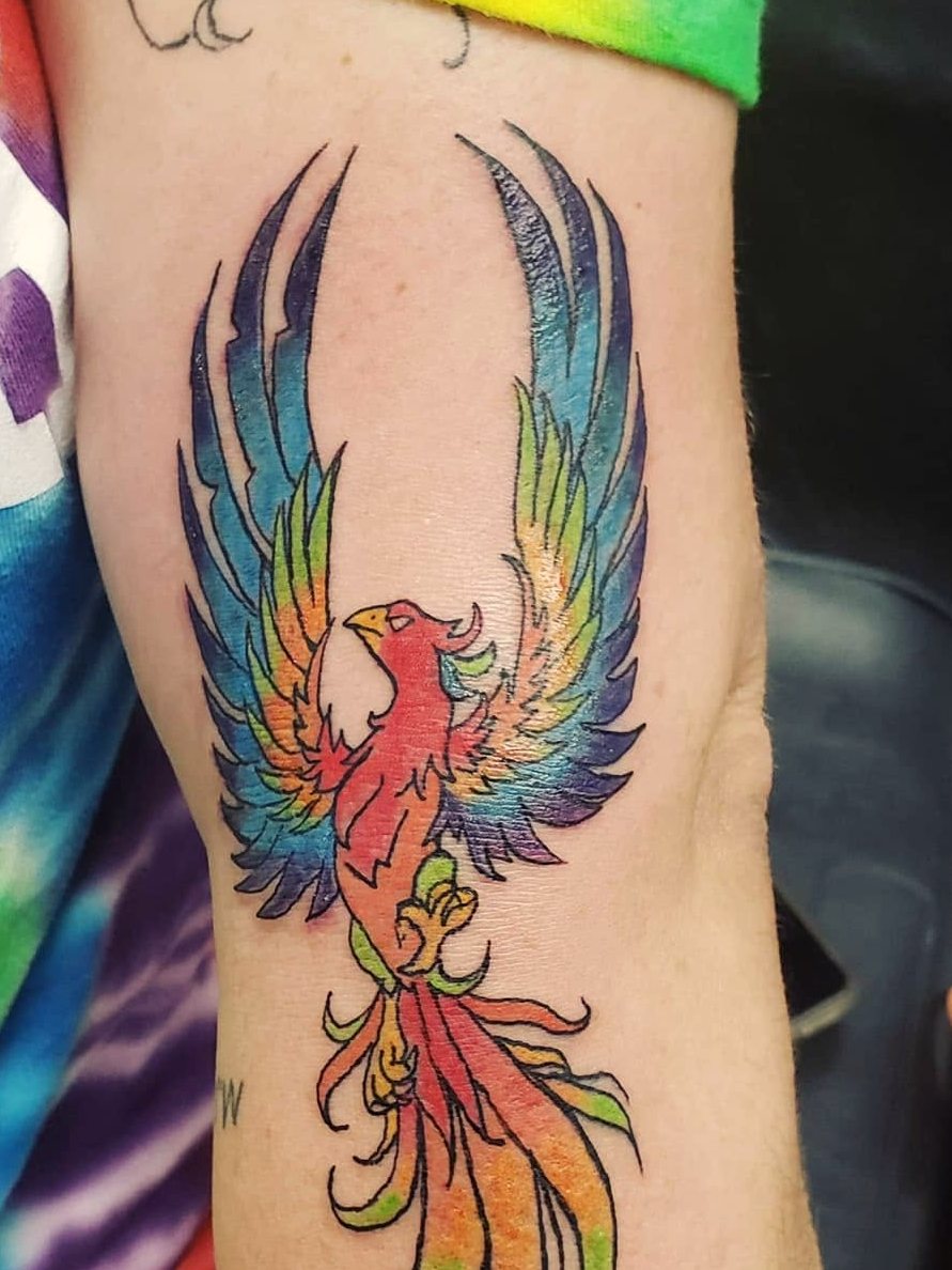 Vibrant full-color phoenix rising, on an upper arm.